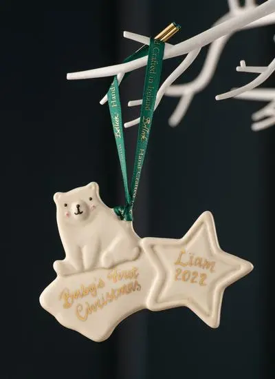 Festive styled shot of Belleek Personalized Baby Bear First Christmas Decoration